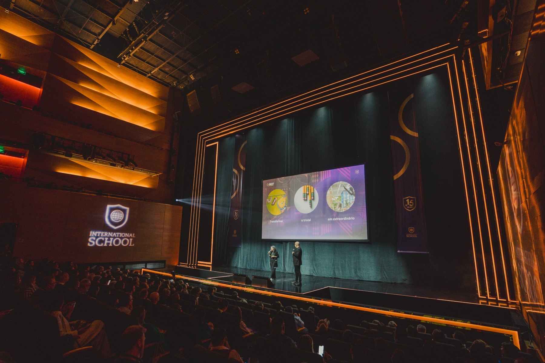 Grande auditório de evento corporativo com palco iluminado